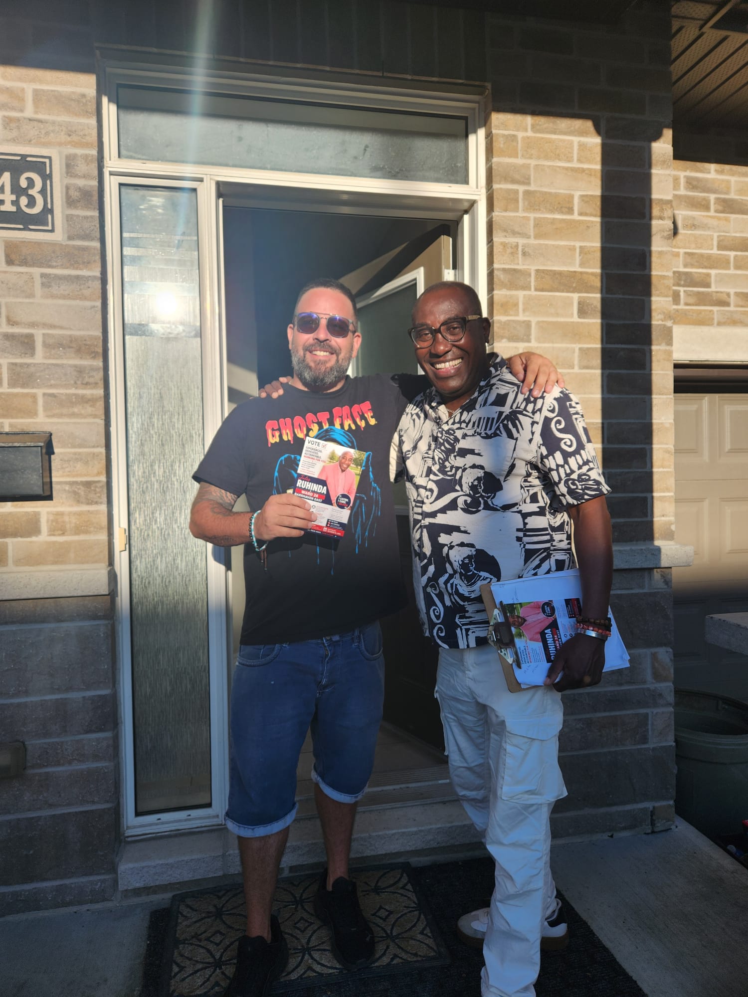 Jules Ruhinda meeting a resident at the door