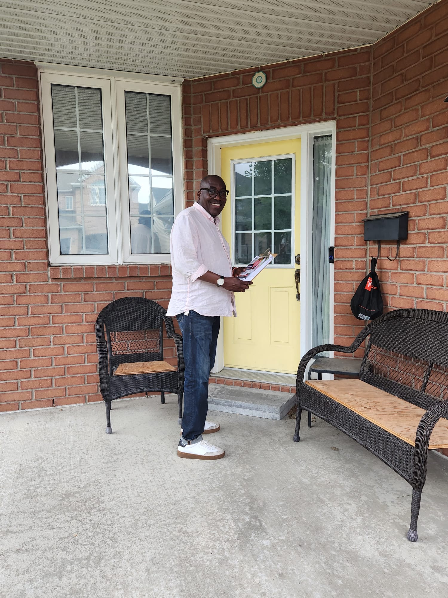 Jules Ruhinda canvassing at a resident's door